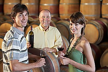 Winemaker Pouring a Young Couple a Glass of Wine