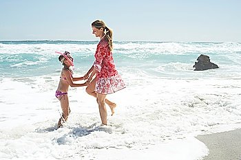 Mother and Daughter Paddling on Beach