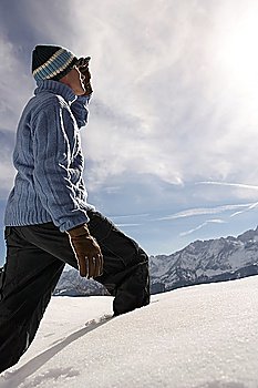 Man walking in fresh snow side view