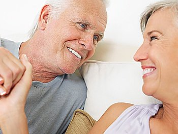 Couple holding hands and looking in eyes close-up