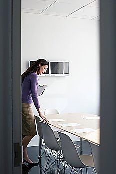 Business woman standing in conference room side view
