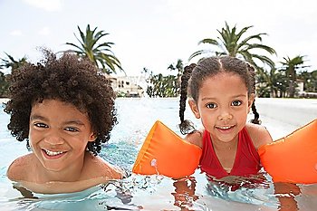 Boy (5-6 years) and girl (5-6 years) in swimming pool