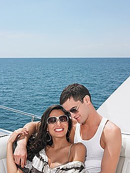 Young couple relaxing on yacht at sea