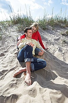 Couple sitting on beach embracing