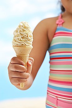 Girl (7-9 years) holding icecream mid section