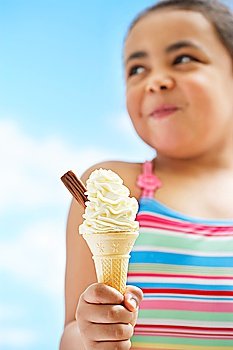 Girl (7-9 years) holding icecream focus on icecream