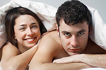 Couple lying in bed portrait close up