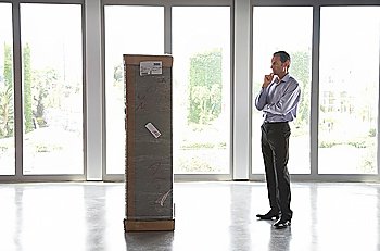Businessman Looking at Large Package