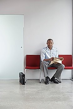 Man Waiting in Office Hallway
