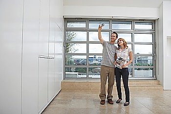 Couple Using Digital Camera in New Apartment
