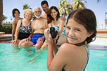 Girl Videotaping Family in Swimming Pool