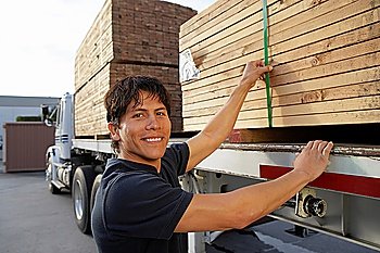 Young Man Checking Load on Truck Trailer