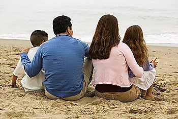 Family Sitting on the Beach