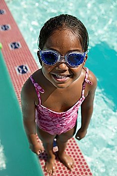 Girl Wearing Goggles on Edge of Swimming Pool