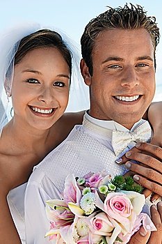 Bride and Groom With Bouquet on Beach