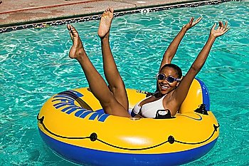 Woman Raising Arms and Legs in Pool Float