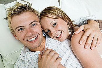 Young Couple Cuddling in Bed