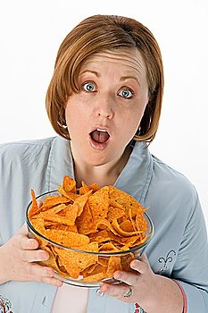 Mid-adult woman holding bowl of potato chips