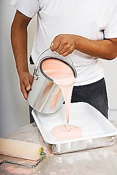 Man Pouring Paint Into Tray