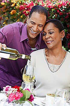 Man Pouring a Glass of Wine for His Wife