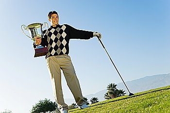 Young Man Holding Golf Trophy