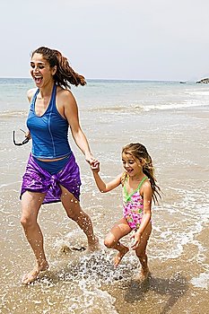 Mother and Daughter Running Through Water on Beach