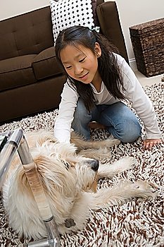 Girl (10-12) playing with dog
