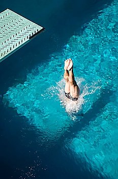 Swimmer diving into swimming pool