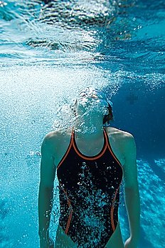Young female swimmer in swimming pool