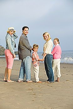 Family standing on beach, portrait