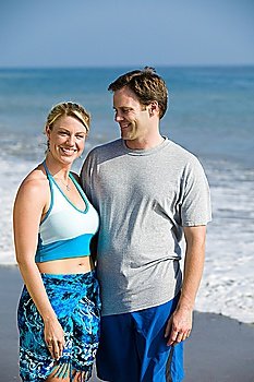 Couple standing on beach, portrait