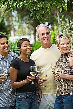 Two couples drinking wine outdoors