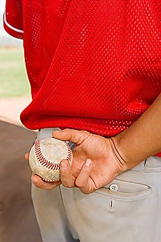 Pitcher Holding Baseball Behind His Back
