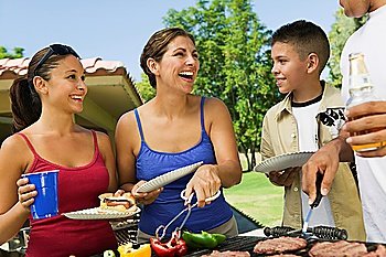 Family Gathered Around Grill