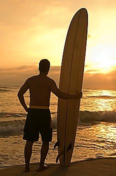 Longboard Surfer Enjoying Sunset on Beach