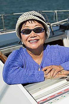 Smiling Woman in Sunglasses on Sailboat