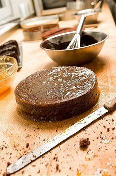 Preparing chocolate cake with filling in the kitchen