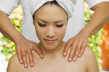 Young woman having shoulder massage at health spa