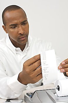 Man Looking at Calculator Tape