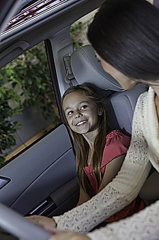 Daughter sitting in car with her mother
