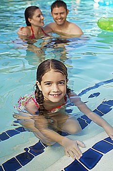 Girl with parents in swimming pool, portrait