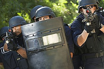 Swat officers with gun and shield
