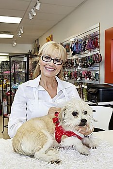 Portrait of senior woman with dog in pet shop