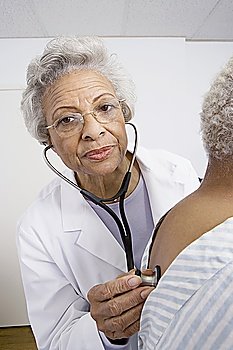 Senior medical practitioner examines breathing with stethoscope