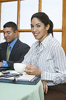 Business people at restaurant, woman looking at camera