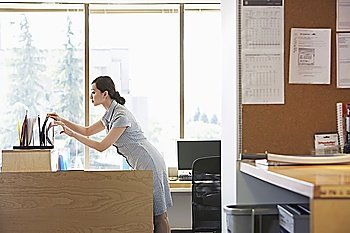 Woman in Office Sorting Documents