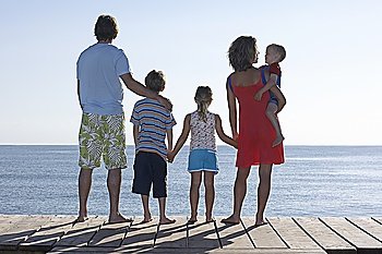 Family with three children (2-11) on jetty