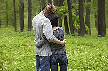 Young Couple Hugging in Forest