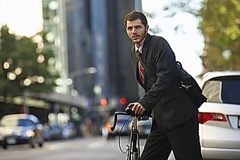 Man standing by bicycle in street, portrait