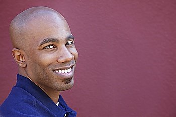 Portrait of a happy African American man over colored background
